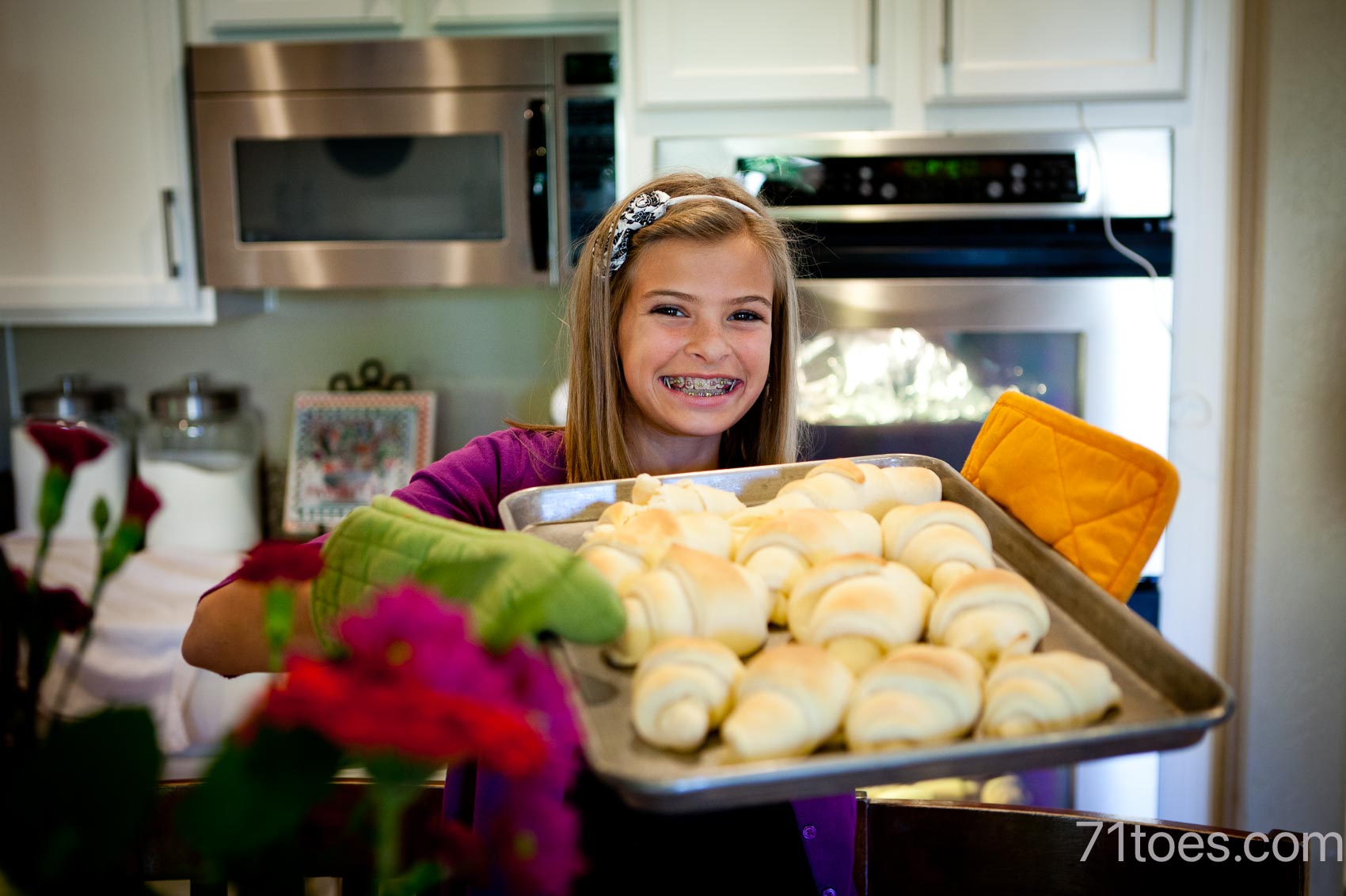 Elle holding freshly baked rolls