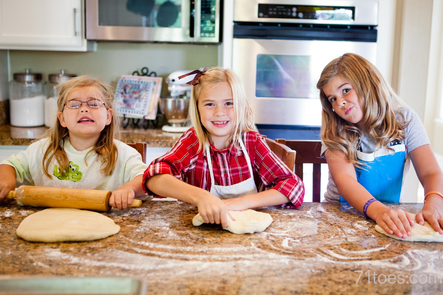 girls rolling out bread