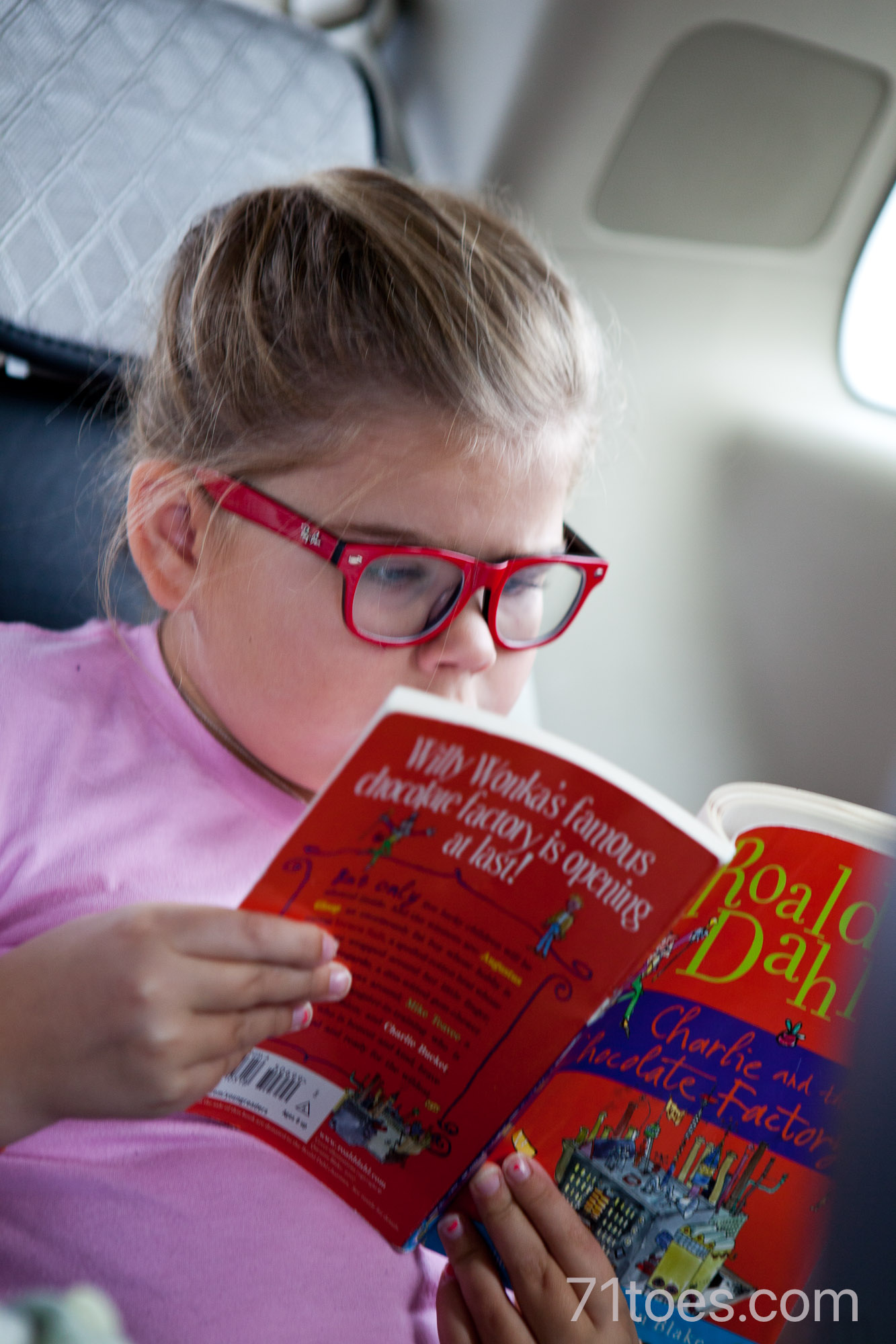 Lucy reading "Charlie and the Chocolate Factory"
