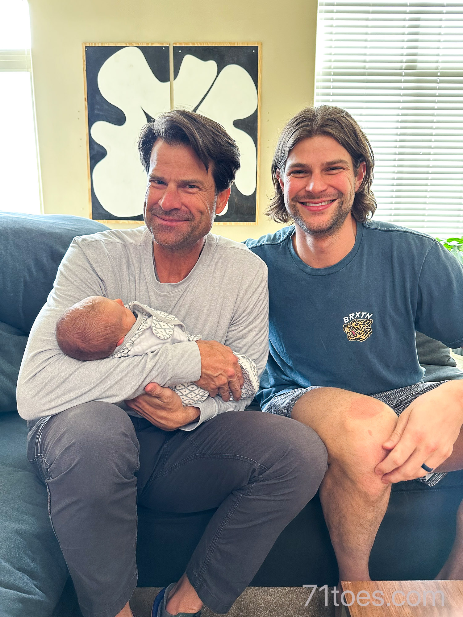 Dad and son with new baby girl: three generations