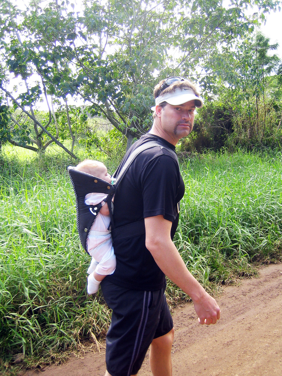 Good dad Dave carrying a baby on his back on a hike.