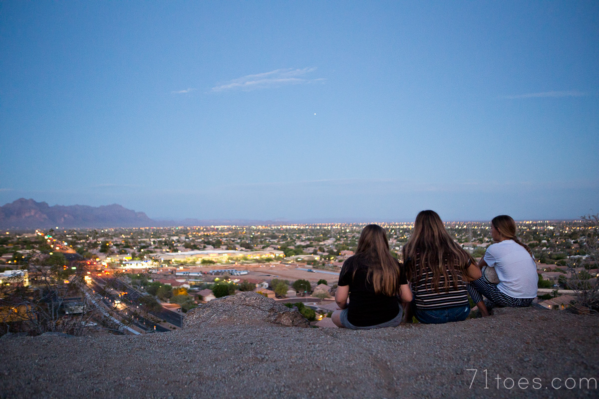 Girls sitting overlooking the valley on a Mother's Day hike