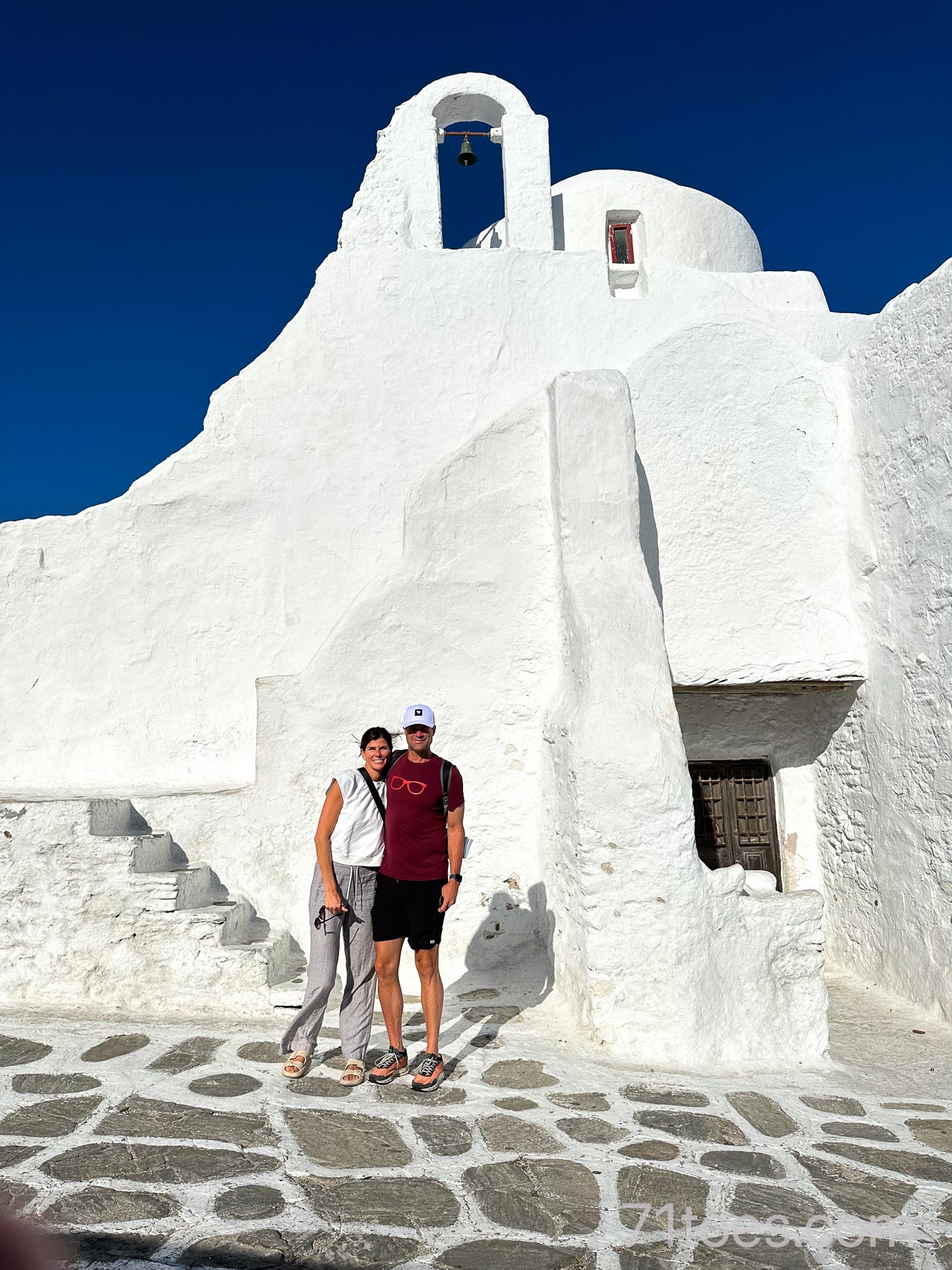 Shawni and David at the Church of Panagia Paraportiani in Mykonos