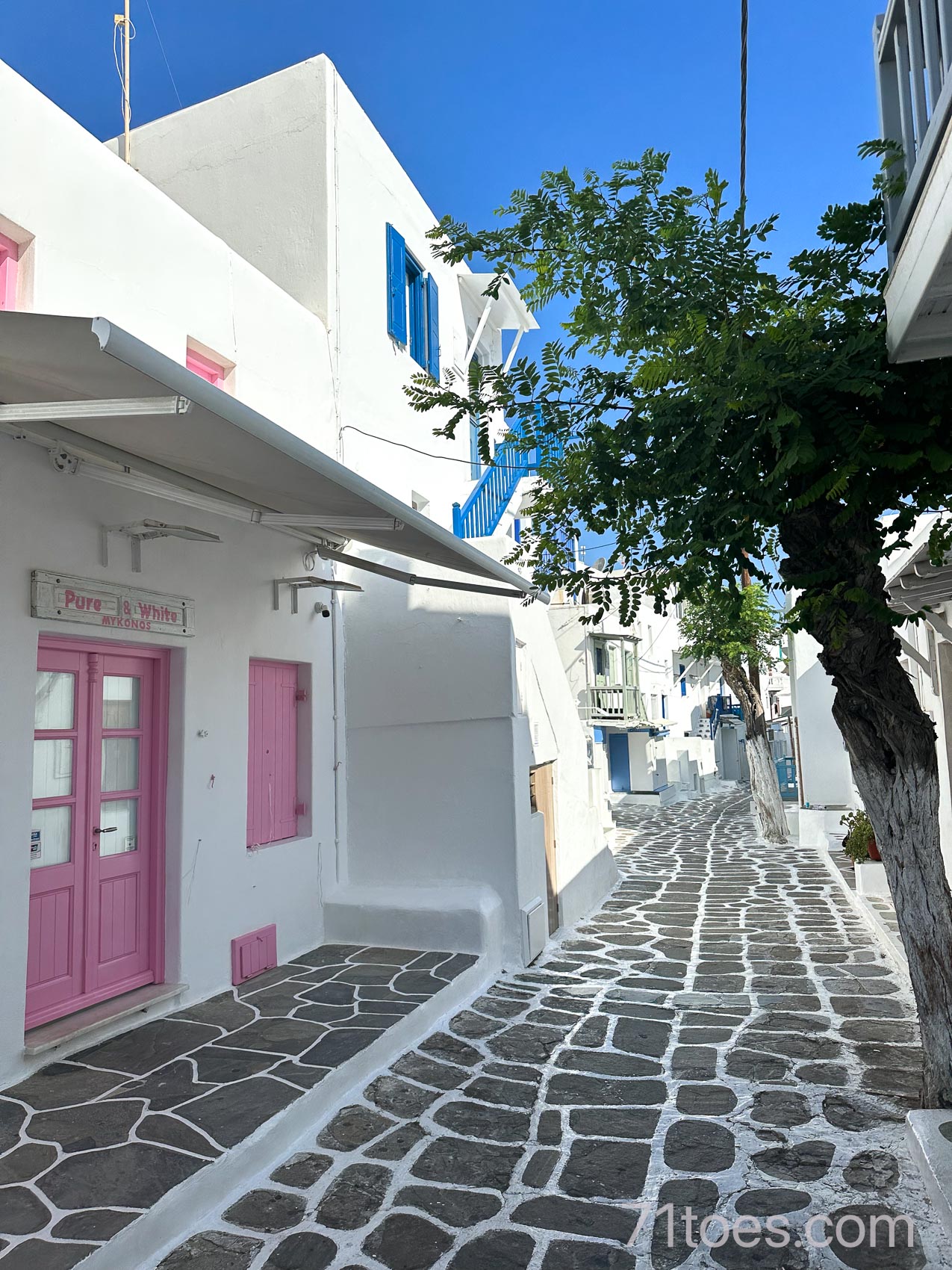 A small alleyway in Mykonos with pink doors