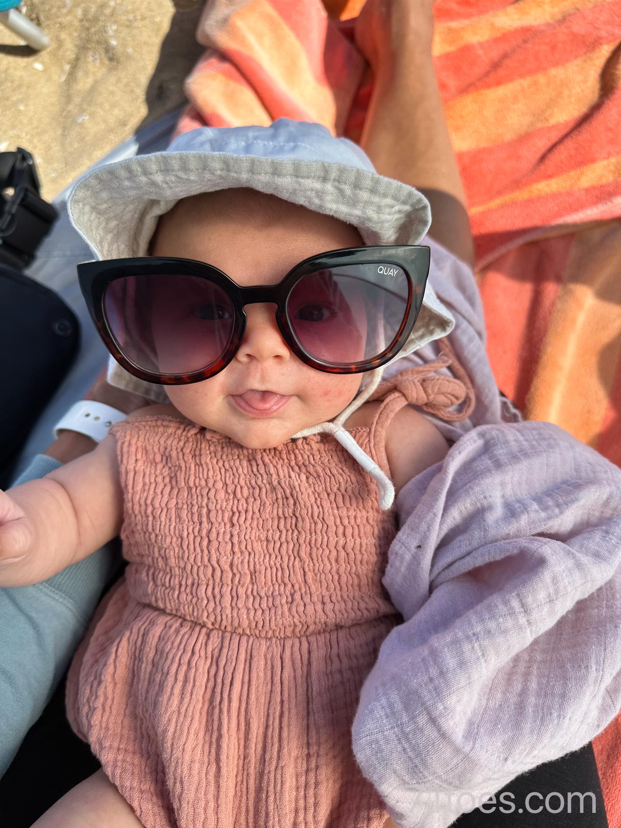 Baby Murphy wearing sunglasses on the beach